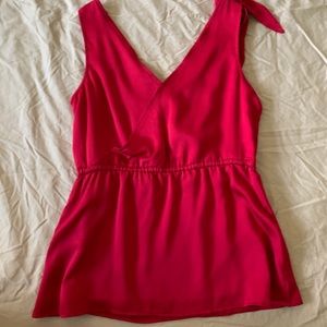 Red sleeveless top.